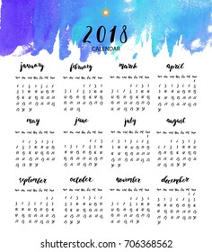 Hand written calendar year 2018 with watercolor blue gradient wash. Week starts Monday. Ink calligraphy elements, numbers, week days, months.