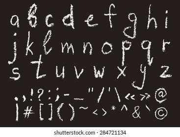 Hand written chalk lowercase english alphabet and most important punctuation marks on black background. Real chalk texture.