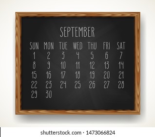 Hand written chalk vector calendar for September 2019 over black chalkboard background in a wooden frame.