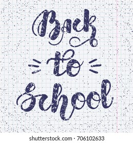 Hand written lettering "Back to school" on copybook background for posters, cards and more. Vector illustration. EPS10.