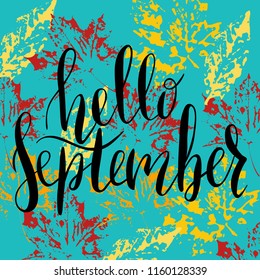 Hand written lettering message hello september.  Autumn welcome quote on color leaves stamp background. Modern colors, yellow, red, cyan. Hello September design for cards, banners, posters.
