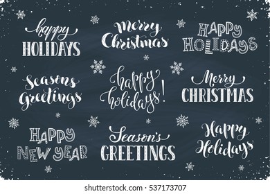 Hand written New Year phrases. Greeting card text template with snowflakes drawn on chalkboard. Happy holidays lettering in modern calligraphy style. Merry Christmas and Season's Greetings lettering.