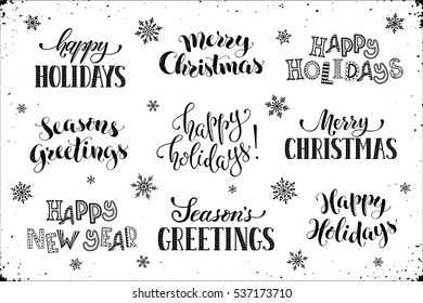 Hand written New Year phrases. Greeting card text  with snowflakes isolated on white background. Happy holidays lettering in modern calligraphy style. Merry Christmas and Season's Greetings lettering.