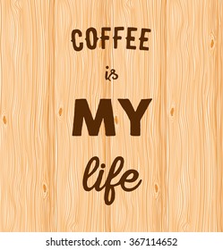 Hand written quote Coffee is my life on wooden background.