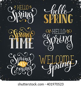 Hand written Spring time phrases in white and gold. Greeting card text templates on blackboard. Hello Spring lettering in modern calligraphy style. Spring wording.