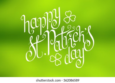 Hand written St. Patrick's day greetings over horizontal abstract smooth blur green background.