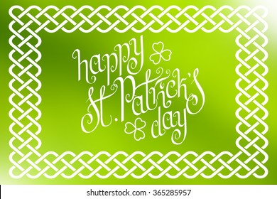 Hand written St. Patrick's day greetings in traditional style braided knot celtic frame over horizontal abstract smooth blur background.