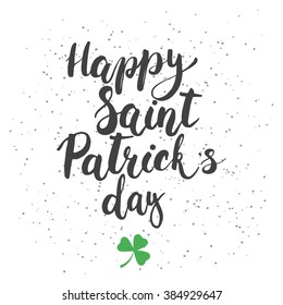 Hand written typography lettering phrase Happy Saint Patric's Day with clover on the white background . Modern calligraphy background for typography greeting with Happy Saint Patric's Day