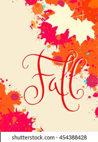 Hand written word Fall in a bright orange and red watercolor paint splatter frame with maple leaves. Contemporary calligraphy.