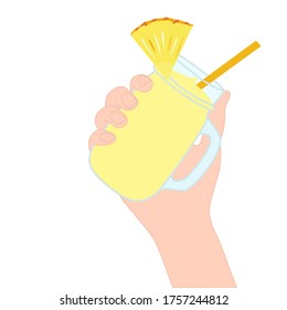 Hand is holding​ a yellow smoothie juice in a glass cup with and has pineapple slice on top. A cold soft drink for summer. Healthy beverage. Tasty and yummy food. A takeaway Product advertisement.