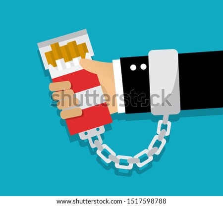 handcuffed hand chained to a pack of cigarettes