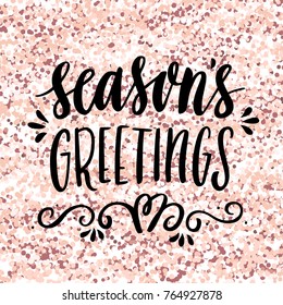 The hand-drawing quote: Season's Greetings, on a pink gold glitter background. Merry Christmas card. It can be used for card, mug, brochures, poster, t-shirts, phone case etc. 