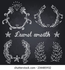 Hand-drawn chalk vector victory laurel wreaths on a black chalkboard background 