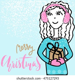 Handdrawn girl holding a gift box with handwritten inspiration. Merry christmas calligraphy.
