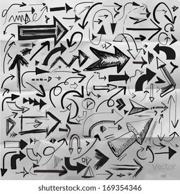 Hand-drawn isolated sketchy arrows set on crumpled paper