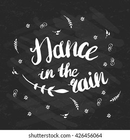 Hand-drawn lettering "Dance in the rain" with flowers. Vector phrase on black background. Quote for print, web, banners, advertisement and clothes.