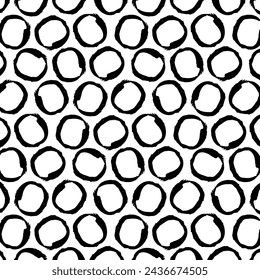 A hand-drawn, seamless, black and white vector pattern featuring a grid of grunge circles. This edgy design adds a contemporary touch, suitable for textiles, posters, cards, banners.