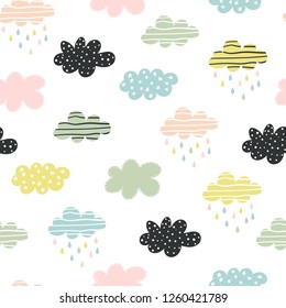 Hand-drawn seamless pattern with cute colorful clouds on a white background. Vector illustration for children.