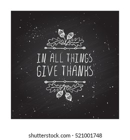 Handdrawn thanksgiving label with acorns and text on chalkboard background. In all things give thanks.