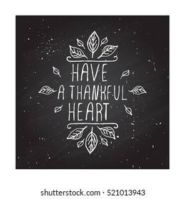 Handdrawn thanksgiving label with leaves and text on chalkboard background. Have a thankful heart.