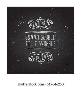 Handdrawn thanksgiving label with pumpkins, maple leaves and text on chalkboard background. Gonna gobble til I wobble.