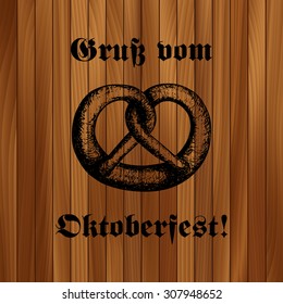 Hand-drawn vector illustration of a pretzel. Traditional Oktoberfest snack on wooden background. Oktoberfest celebration design, eps10.
Text in German: "Greetings from Oktoberfest!"