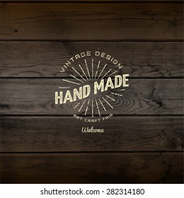 Handmade badges logos and labels for any use, on wooden background texture