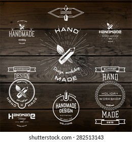 Handmade badges logos and labels for any use, on wooden background texture