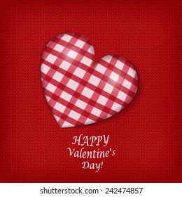 Handmade checkered heart  on red knitted background.
