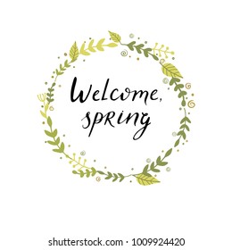 Handmade lettering - Welcome spring isolated in floral wreath. 
