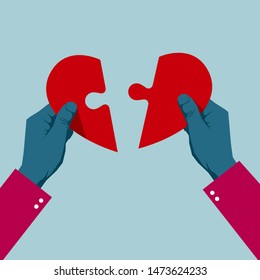 Hands assemble the heart symbol. Isolated on blue background.