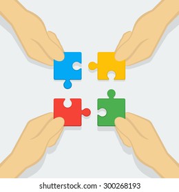 Hands assembling jigsaw puzzle - business concept