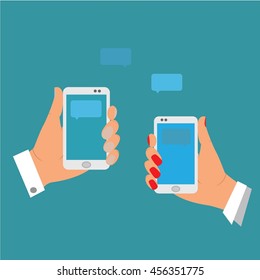 the hands of a boy and a girl holding a cell phone, send each other SMS