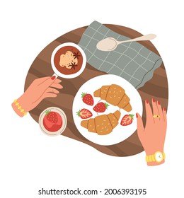 Hands and breakfast. Top view morning meals, croissants with strawberry and jam. Cup of spiced coffee or tea, character takes pastries for lunch in cafe vector cartoon isolated illustration