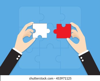 hands of businessman putting wrong way jigsaw puzzle pieces