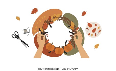Hands carefully crafting a rustic autumn wreath decorated with small orange pumpkins, autumn foliage, thread, and sharp metal scissors nearby.