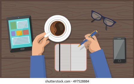 Hands with Cup Of Coffee and Pen in Workspace