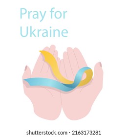 Hands with the flag and the call to pray for Ukraine