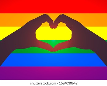 Hands folded in the shape of  heart on a rainbow background. Symbol of tolerance for LGBT community, same-sex and transgender love. Gay pride is the outlook, that bolsters most LGBT rights movements.