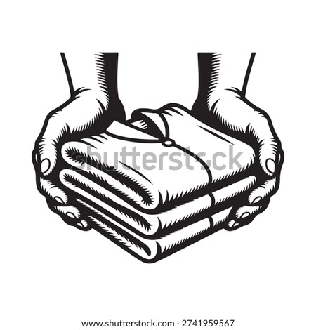 Hands gently holding a neatly folded stack of clothing items