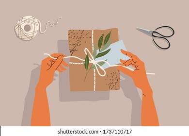 Hands and gift box on the table. Trendy illustration of hands, gift box, scissors and tree branch. On the table, top-down view. Hand-drawn modern illustration for web and print.