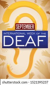 Hands helping and supporting a golden ear, with label and calendar symbolizing the support and awareness to the deaf people during International Week of the Deaf in September.