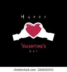 Hands hold a bright heart on a black background. Happy Valentine's Day.