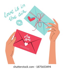 Las manos sostienen una carta con un mensaje de amor y la inscripción amor está en el aire. Concepto de San Valentín