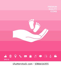 Hands holding baby foot
