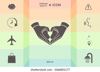 Hands holding baby - protection symbol. Heart shape made with hands