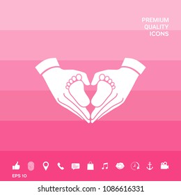 Hands holding baby - protection symbol. Heart shape made with hands