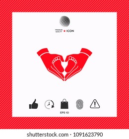 Hands holding baby - protection symbol. Heart shape made with hands