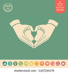 Hands holding baby - protection symbol. Heart shape made with hands