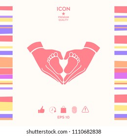 Hands holding baby - protection symbol. Heart shape made with hands